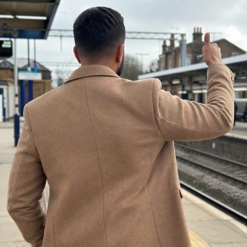 Man giving a thumbs up on a train platform